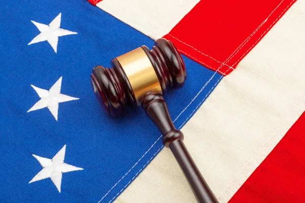 Wooden judge gavel over US flag - closeup shoot — Stock Photo, Image