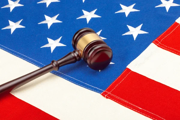Wooden judge gavel over US flag — Stock Photo, Image