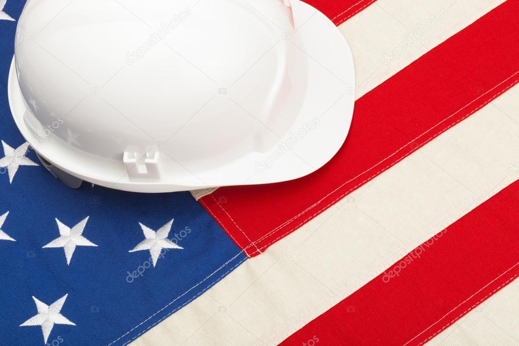 White color construction helmet laying over US flag