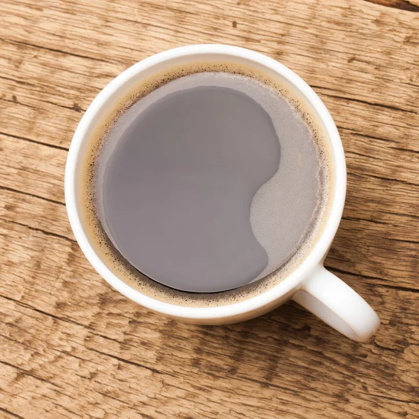 Coffee in white ceramic cup on wooden table - 1 to 1 ratio — Stock Photo, Image