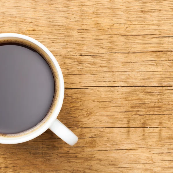 Black coffee in white ceramic cup on wooden table - view from to - 1 to 1 ratio — Stock Photo, Image