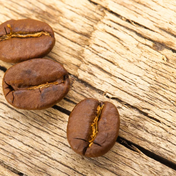 Roasted coffee beans on old wooden table - 1 to 1 ratio — Stock Photo, Image