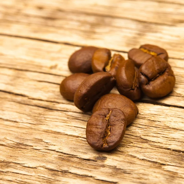 Roasted coffee beans on old wooden table - 1 to 1 ratio — Stock Photo, Image