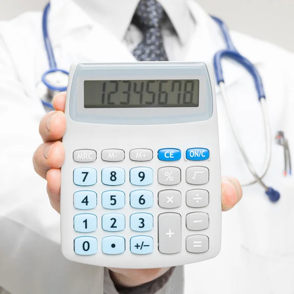 Doctor holding in his hand calculator - closeup shot - 1 to 1 ratio — Stock Photo, Image