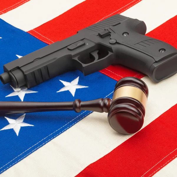 Wooden judge gavel and gun over USA flag - studio shoot - 1 to 1 ratio — Stock Photo, Image