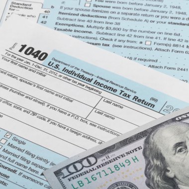 US Tax Form 1040 with 100 dollars banknote above it - 1 to 1 ratio clipart
