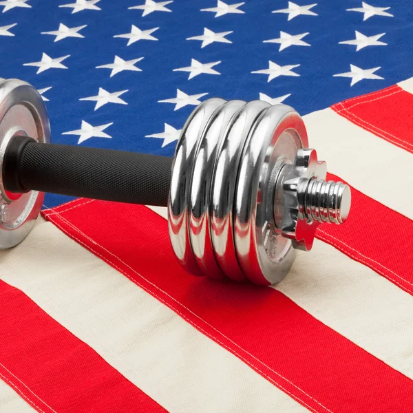 Dumbbell weights above US flag as symbol of healthy nation - 1 to 1 ratio — Stock Photo, Image