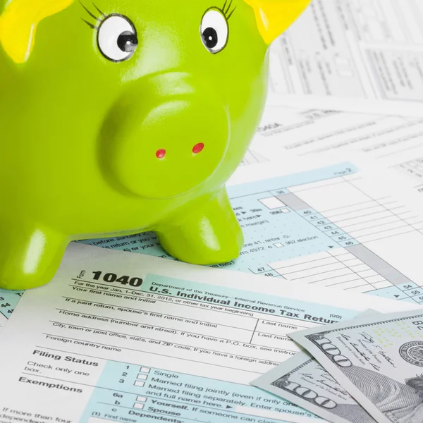 US Tax Form 1040 with green piggy bank and dollars - 1 to 1 ratio