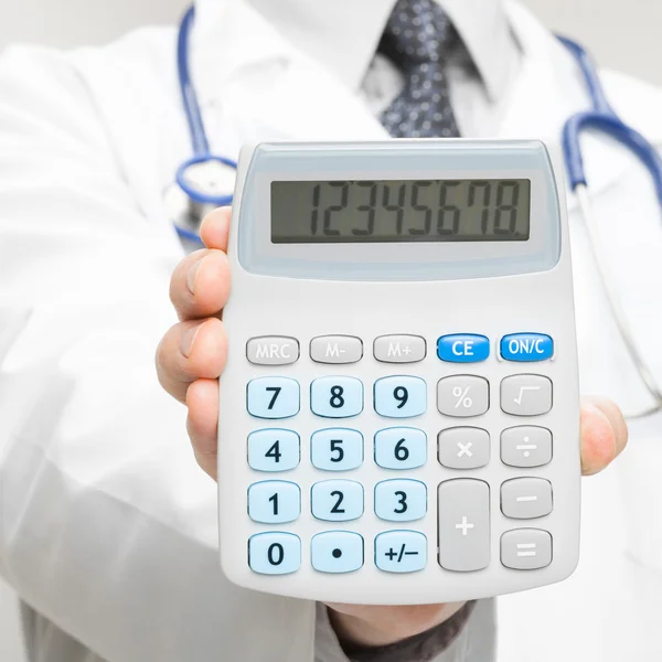 Medical doctor holding in his hand calculator - 1 to 1 ratio — Stock Photo, Image