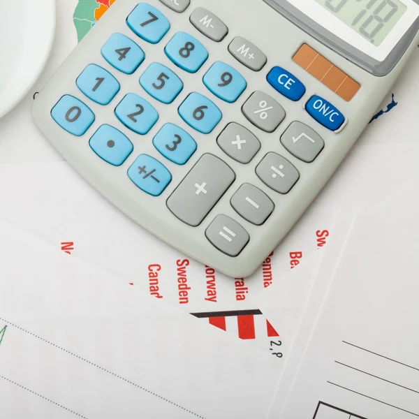 Calculator over some financial documents and charts - 1 to 1 ratio — Stock Photo, Image