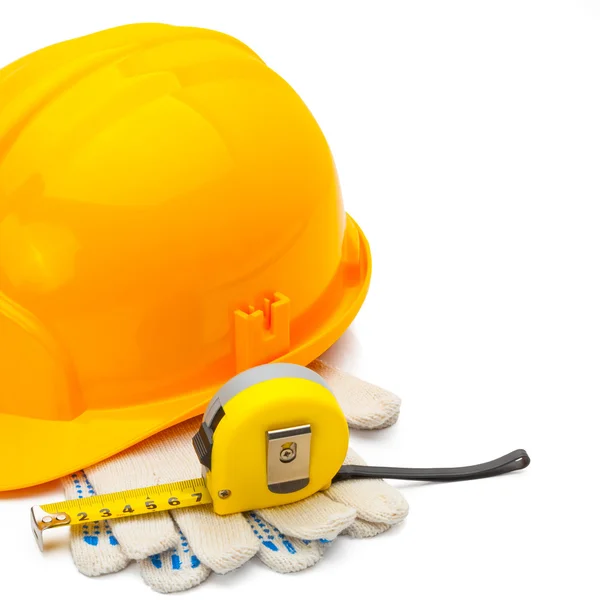 Construction helmet with measure tape and gloves on white background - 1 to 1 ratio — Stock Photo, Image