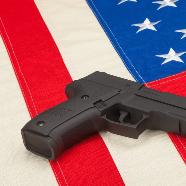 Studio shot of handgun over USA flag - 1 to 1 ratio — Stock Photo, Image