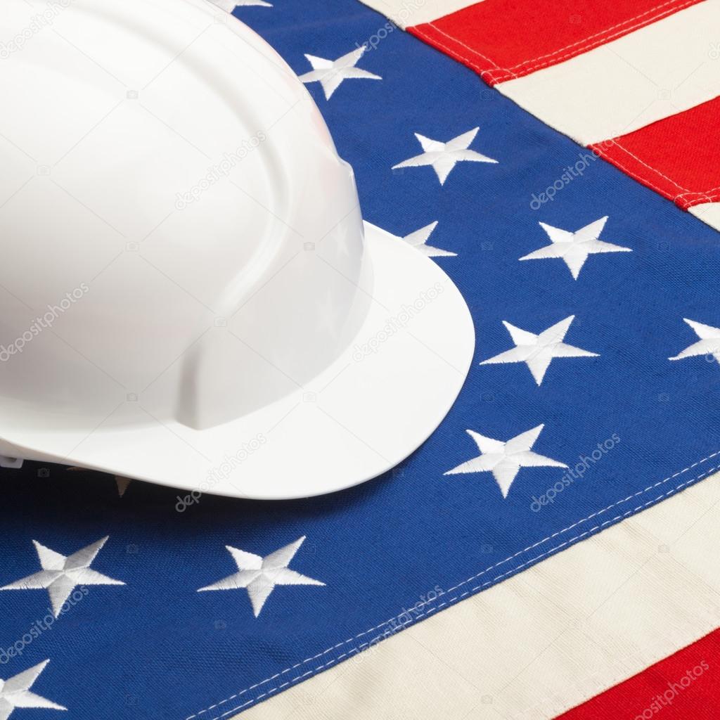 Construction helmet laying over US flag - 1 to 1 ratio