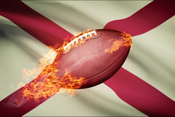 Futbol amerykański piłkę z flagą w backround serii - alabama — Zdjęcie stockowe