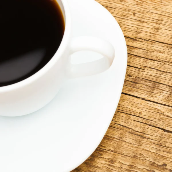 Wooden table with ceramic coffee cup on it - view from top - 1 to 1 ratio — Stock Photo, Image