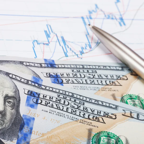 Dollars banknote with pen over stock market chart - 1 to 1 ratio — Stock Photo, Image