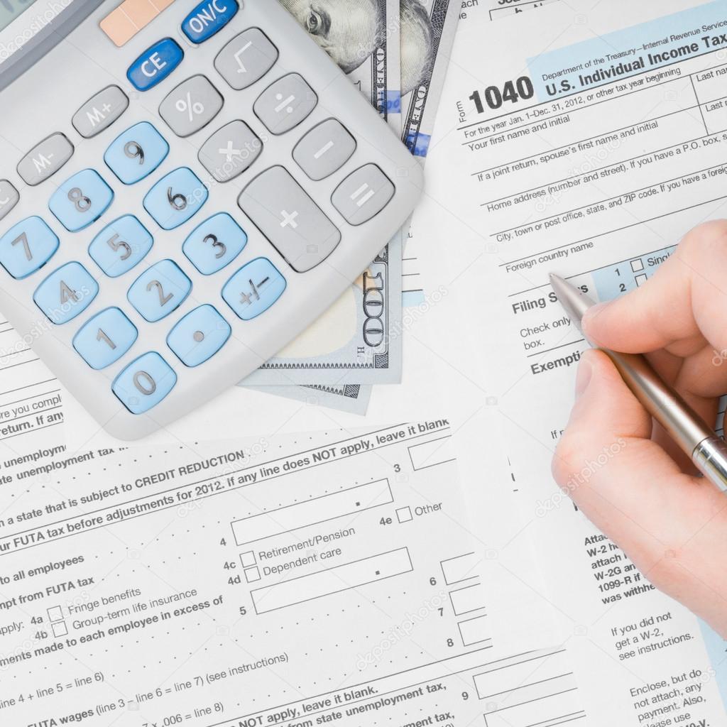 Man filling out 1040 US Tax Form - view from top - 1 to 1 ratio