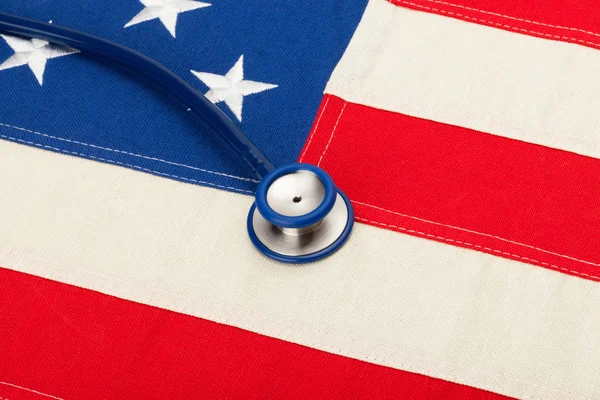 Stethoscope over US flag - heath care concept — Stock Photo, Image