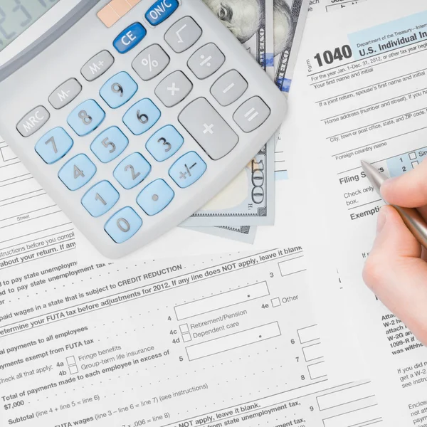 Filling out 1040 US Tax Form - view from top — Stock Photo, Image