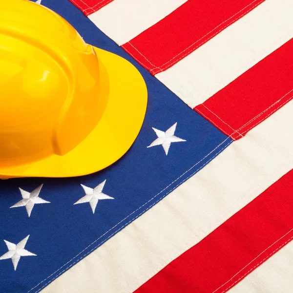 Construction helmet over US flag — Stock Photo, Image