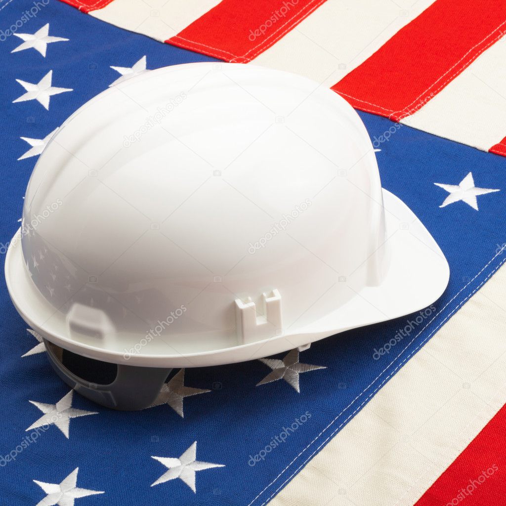 White construction helmet over US flag - closeup shot
