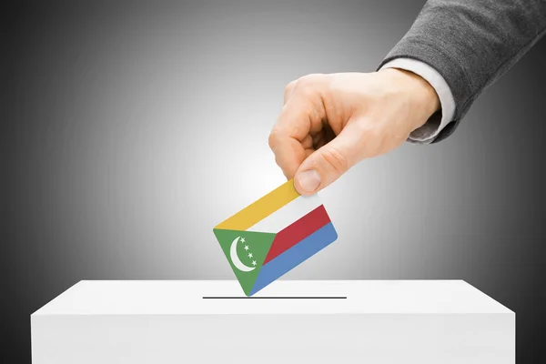 Voting concept - Male inserting flag into ballot box - Comoros — Stock Photo, Image