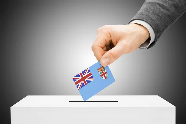 Voting concept - Male inserting flag into ballot box - Fiji - Stock-foto