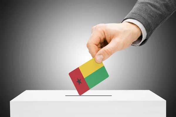 Voting concept - Male inserting flag into ballot box - Guinea-Bissau — Stock Photo, Image