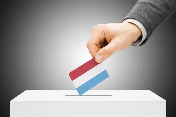 Voting concept - Male inserting flag into ballot box - Luxembourg — Stock Photo, Image