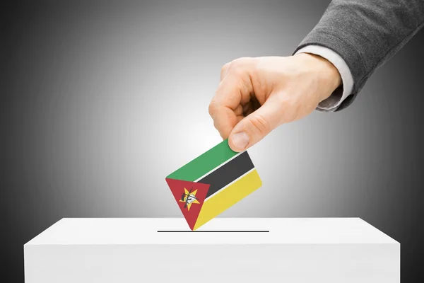 Voting concept - Male inserting flag into ballot box - Mozambique — Stock Photo, Image