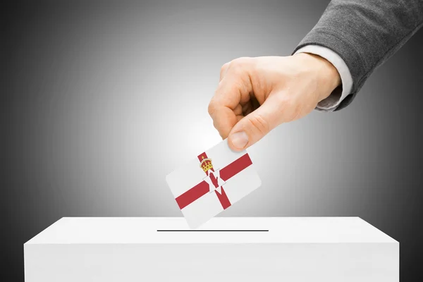 Voting concept - Male inserting flag into ballot box - Northern Ireland — Stock Photo, Image