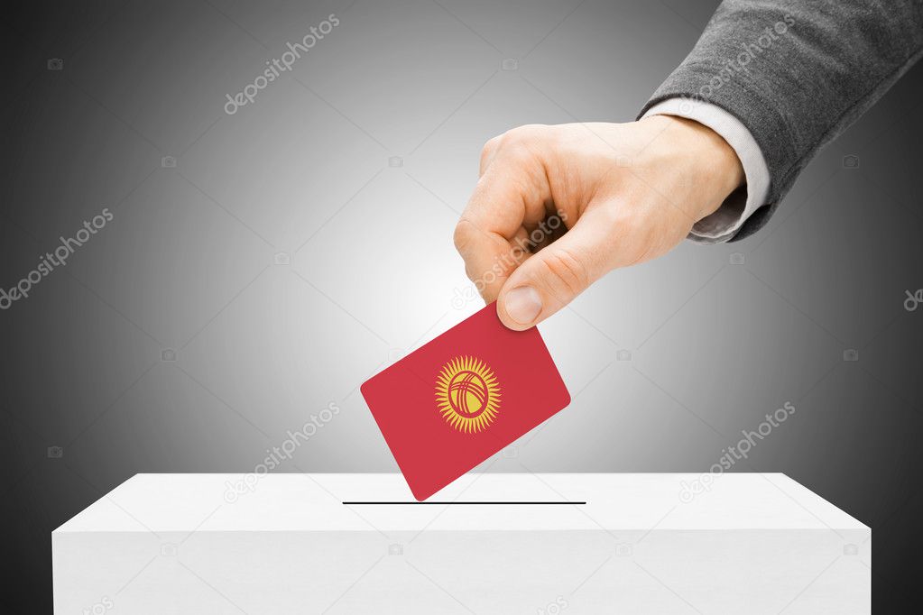Voting concept - Male inserting flag into ballot box - Kyrgyzstan