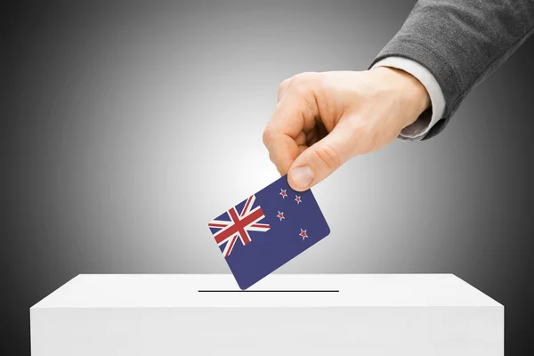 Voting concept - Male inserting flag into ballot box - New Zealand — Stock Photo, Image