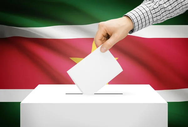 Voto concepto - urna con la bandera nacional de fondo - Surinam —  Fotos de Stock