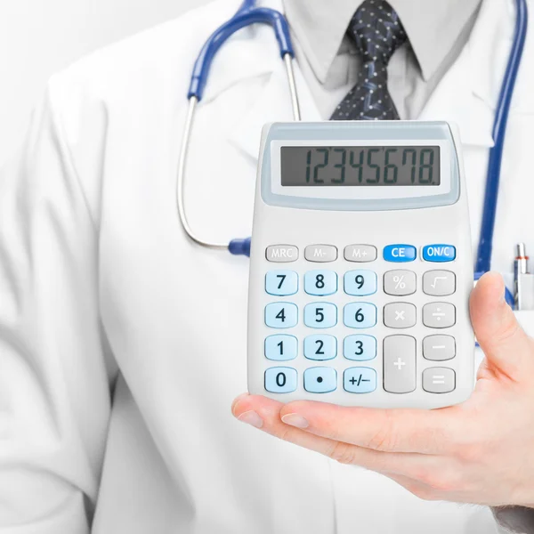 Doctor holdling in his hand calculator - medical aid concept — Stock Photo, Image