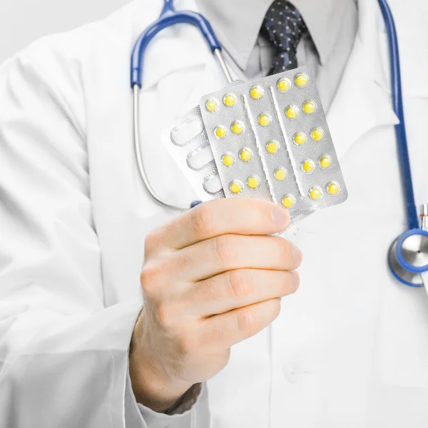 Doctor holdling pills in his hand - medical aid concept — Stock Photo, Image