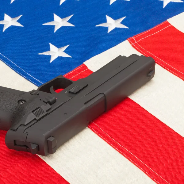 Handgun laying over USA flag - self-defense law concept — Stock Photo, Image
