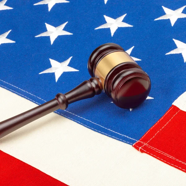 Wooden judge gavel over US flag - court judgment concept — Stock Photo, Image