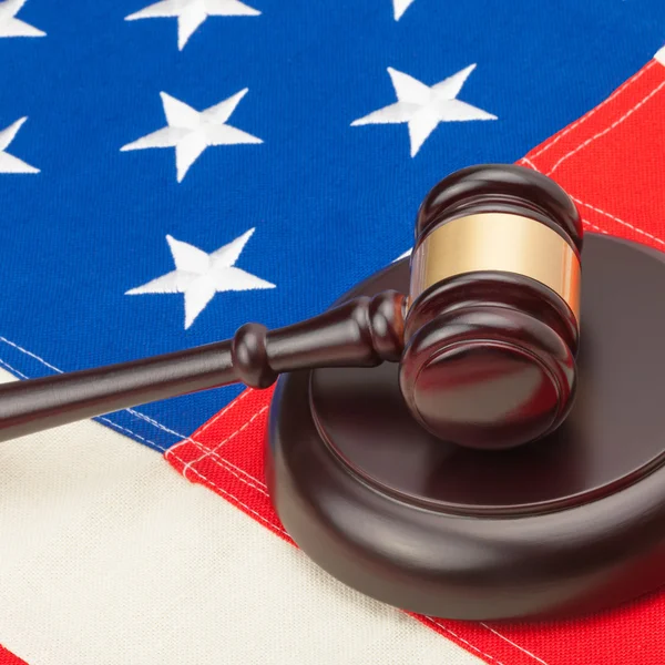 Wooden judge gavel and soundboard laying over USA flag - court judgment concept — Stock Photo, Image