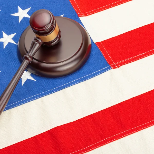 Wooden judge gavel and soundboard laying over US flag - court judgment concept — Stock Photo, Image