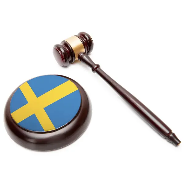 Молоток судьи и деки с национальным флагом на нем - Швеция — стоковое фото