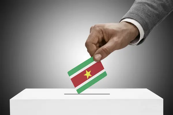 Black male holding flag. Voting concept - Surinam — Stock Photo, Image