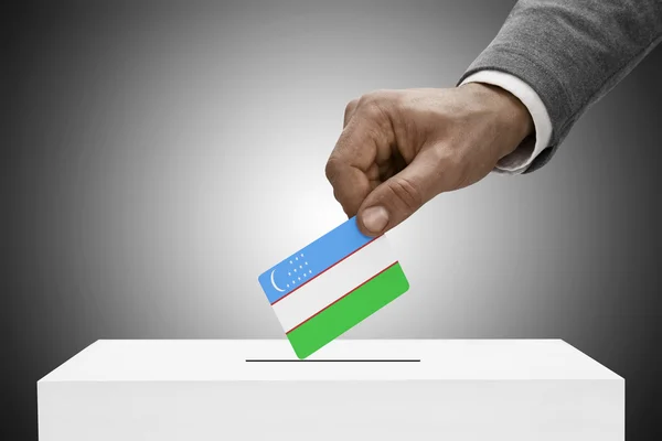 Black male holding flag. Voting concept - Uzbekistan — Stock Photo, Image