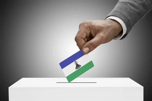 Black male holding flag. Voting concept - Lesotho — Stock Photo, Image