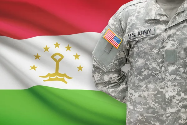 American soldier with flag on background - Tajikistan — Stock Photo, Image