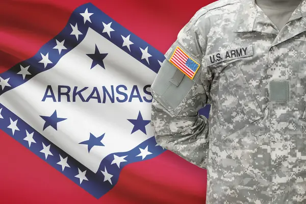 American soldier with US state flag on background - Arkansas — Stock Photo, Image