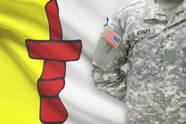 American soldier with Canadian province flag on background - Nunavut — kuvapankkivalokuva