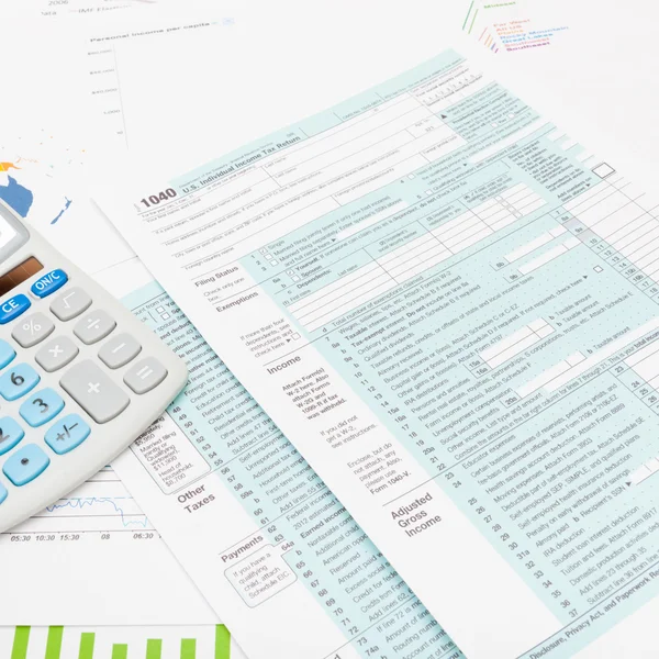 US 1040 Tax Form and calculator - studio shot — Stock Photo, Image