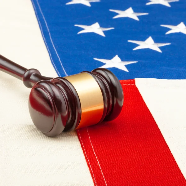 Wooden judge gavel over USA flag - closeup studio shot — Stock Photo, Image