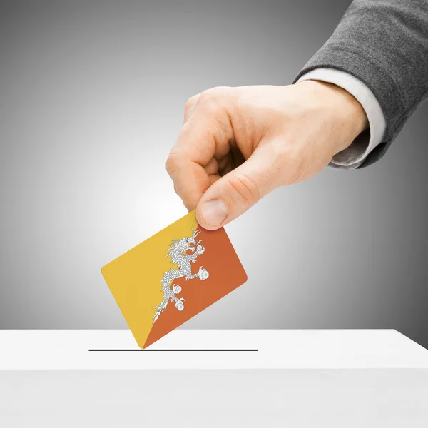 Voting concept - Male inserting flag into ballot box - Bhutan — Stock Photo, Image